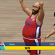 A chubby balding bearded man in glasses celebrates a basketball win